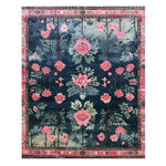 A stunning Blushing Rose Garden Hand-Tufted Area Rug, perfect for the living room or dining room. This elegant wool rug measures 8x10 and features a bold floral design with pink and green hues against a deep blue background, adding a touch of sophistication to any space.