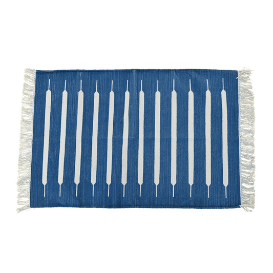 Elevate your space with the timeless elegance of the "Handwoven Blue and White Mini Stripe Cotton Rug with Fringes." Its classic mini stripe pattern in blue and white exudes sophistication, while the fringes add a charming touch. Handcrafted with care, this rug brings both style and comfort to any room in your home.