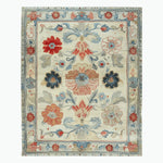 Elegant hand-tufted wool area rug featuring a classic floral pattern in vibrant reds, blues, and beiges, perfect for large living rooms. This 8x10 rug adds a touch of antique charm to any space.