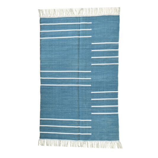 Elevate your space with the timeless charm of the "Handwoven Denim Blue and White Minimalistic Cotton Rug with Fringes." Its clean lines and minimalist design in denim blue and white hues exude modern sophistication, while the fringes add a touch of texture and whimsy. Handcrafted with care, this rug brings both style and comfort to any room in your home.