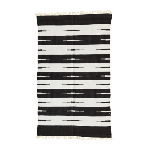 Enhance your space with timeless elegance using the "Handwoven Black and White Classic Stripe Cotton Rug with Fringes." Its classic stripe pattern in bold black and white hues exudes sophistication and charm, while the fringes add a delightful accent. Handcrafted with care, this rug brings both style and comfort to any room in your home, creating a stylish and inviting atmosphere