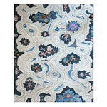 Top view of the Azure Blossom Wave Hand Tufted Area Rug, featuring an abstract floral design in shades of blue, black, and orange, perfect for adding a touch of elegance to your living room or office space. This wool rug combines style and comfort, making it an ideal choice among rugs for office settings.