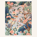 The Blossom Retreat Hand Tufted Rug showcases a serene nature scene with vibrant pink blossoms and intricate branches, perfect for enhancing a living room. The area rug, crafted from high-quality wool, features a stunning design that adds elegance and warmth to any living room space.