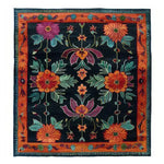 Vibrant hand-tufted wool area rug featuring a bold floral design with rich colors, perfect as a dining table rug in a dining room setting.