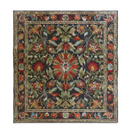 A beautifully intricate area rug, perfect for the living room, showcasing a traditional hand-tufted design with vibrant floral and foliage patterns. This large wool rug adds a touch of classic elegance to any living room space.