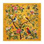 Vibrantly colored area rug, perfect for a large living room, featuring an intricate design of birds perched on blooming branches against a warm yellow background. This hand-tufted wool rug adds a touch of elegance and nature-inspired beauty to any living space.
