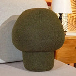 Faux wool mushroom shaped throw pillow in a rich green color, perfect for adding a whimsical touch to any living space.