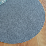 Round blue rug on a wooden floor