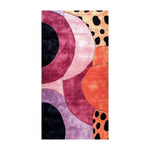 A vibrant geometric animal print area rug, perfect for adding a contemporary touch to your living room, hallway, or kitchen. This hand-tufted wool rug features bold circles and abstract patterns in shades of purple, orange, and black, making it an eye-catching addition to any space. Ideal as a hallway runner rug, kitchen runner rug, or a large living room area rug.