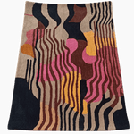 Colorful abstract patterned rug on a dark background
