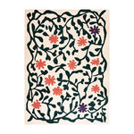 Vibrant area rug with an abstract floral meadow design. The rug features bold green vines and bright flowers on a soft background, adding a touch of nature-inspired elegance to any room.