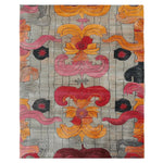 This vibrant Baroque Fire Bloom hand-tufted area rug features an intricate abstract design with bold red, orange, and pink floral patterns set against a subtle gray background. The luxurious texture and unique motifs make it a statement piece for any room.