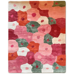 Vibrant Blossom Mosaic Hand Tufted Wool Area Rug featuring an abstract floral pattern in shades of pink, red, orange, and green. This artistic design adds a pop of color and modern flair to any room, showcasing a variety of stylized blooms across its surface.