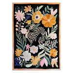 A vibrant, hand-tufted wool area rug featuring a whimsical design of large colorful flowers interwoven with zebra stripes on a dark background, offering a bold and artistic touch to any room.