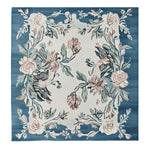 The Blossom Serenade Tapestry Hand Tufted Rug is a stunning square area rug perfect for adding elegance to your living room. This wool rug features a beautiful floral design with intricate blossoms and leaves in soft pink and green hues on a rich blue background. Ideal for those seeking rugs for living room spaces, this 8x10 square rug offers a luxurious touch and a cozy feel.