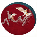 The "Crimson Flight Hand Tufted Round Rug" features a stunning red design, offering elegance, softness, and timeless beauty to any space.