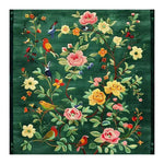 The Emerald Oasis Hand Tufted Area Rug features a vibrant floral design with colorful birds on a rich green background. This elegant wool rug is perfect for adding a touch of nature to your living room or dining room, making it an ideal choice for those seeking stylish living room and dining room rugs or dining room carpets.