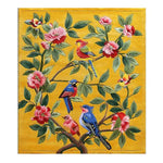 A vibrant hand-tufted area rug featuring colorful birds perched on branches with lush green leaves and pink flowers, set against a warm yellow background. Perfect for adding a touch of nature to your living room decor, this wool rug enhances the elegance of any living space.