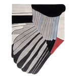 A close-up view of the Feathered Geometry Hand Tufted Area Rug, showcasing its abstract design with bold black, grey, and red patterns. This contemporary wool rug is perfect for adding a modern touch to living room spaces, making it an ideal choice for those seeking stylish living room area rugs.