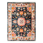 Top view of the Palace Legacy Hand Tufted Wool Rug, showcasing an intricate and colorful abstract design. This area rug features vibrant pink, orange, and blue patterns, ideal for elevating any living room decor.