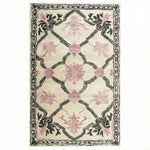 Elegant Petal Veil Mosaic Hand Tufted Area Rug, perfect for adding a vintage touch to your living room or dining room. The design features delicate pink floral patterns with intricate black detailing on a cream background, ideal for living room rugs 8x10 or as a wool rug centerpiece.