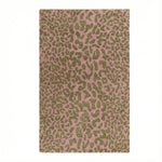Pink rug with green leopard print pattern on a white background