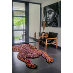 A vibrant Red Leopard Yogi Accent Wool Rug adds a touch of bold style to this modern living room. Perfect for living room area rugs or as a statement piece in rugs for office, this vintage wool rug features an eye-catching leopard print design, enhancing the room's contemporary decor.