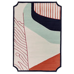 Staircase in a stylish room with decorative wall art and a colorful rug.