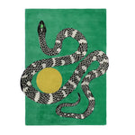 A contemporary wool rug featuring a striking design of a black and white snake intertwined with a yellow sun on a lush green background. Perfect for large living room spaces, this hand-tufted area rug adds a bold statement to any modern decor.