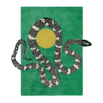 A vibrant area rug featuring a contemporary design with a striking black and white snake coiled around a golden sun on a lush green background. This hand tufted wool rug adds a bold touch to any living room, making it an ideal choice for those seeking unique rugs for their living space.
