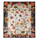 Vibrant floral area rug with a hand-tufted design, featuring a variety of colorful flowers on a contrasting dark border. Perfect for adding a touch of nature to large living rooms, this wool rug combines style and comfort, making it an ideal choice for those seeking elegant rugs for living room spaces.