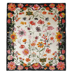 Vibrant floral area rug with a hand-tufted design, featuring a variety of colorful flowers on a contrasting dark border. Perfect for adding a touch of nature to large living rooms, this wool rug combines style and comfort, making it an ideal choice for those seeking elegant rugs for living room spaces.