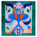 Luxurious living room with green sofa, colorful rug, and decorative mirrors.