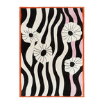 A contemporary area rug featuring bold black and white wavy stripes with abstract floral designs. This hand-tufted wool rug, perfect for a modern living room, measures 8x10 and adds a stylish touch with its vibrant pattern.