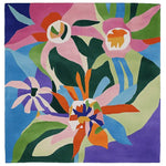 Vibrant Tropical Bloom Riot Hand Tufted Rug featuring bold, abstract floral patterns in vivid colors. This square wool area rug is perfect for adding a contemporary touch to your living room.