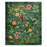 A vibrant Tropical Treasure Hand Tufted Wool Rug depicting lush floral designs and colorful birds on a green background. This large area rug is perfect for adding a touch of elegance to a dining room. Made from high-quality wool, it's an ideal choice for formal dining room settings, providing a warm and inviting atmosphere.