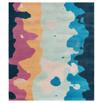 A vibrant hand-tufted area rug featuring an abstract design with bold colors including pink, orange, blue, and cream. This contemporary rug, made from high-quality wool, is perfect for adding a modern touch to any living room setting.