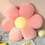Flower-shaped plush throw pillow in pink and yellow, perfect for seating and decoration.