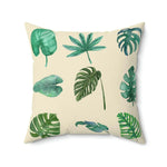 Green monstera leafy printed throw pillow featuring various tropical leaf designs on a cream background.