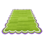 Handmade scalloped cotton area rug in light green with a vibrant border. Perfect for adding a touch of boho style to your dining room or bedroom. Ideal as a formal dining room rug or as a unique under-the-table accent in your dining area.