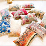 Colorful Moroccan kilim throw pillows arranged artistically on a light surface, showcasing unique patterns and textures, perfect for adding a bohemian touch to any decor.