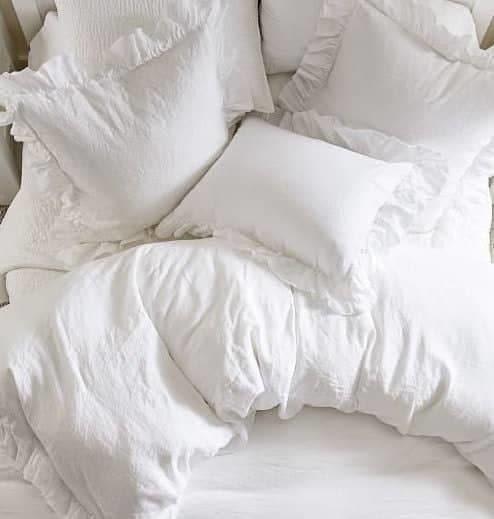 This duvet cover set is crafted entirely from pure linen, offering a luxurious and breathable sleeping experience. The set includes a duvet cover adorned with charming ruffles, adding a touch of elegance to your bedroom decor. The crisp white color enhances the feeling of freshness and purity, perfect for creating a serene and inviting sleeping environment.