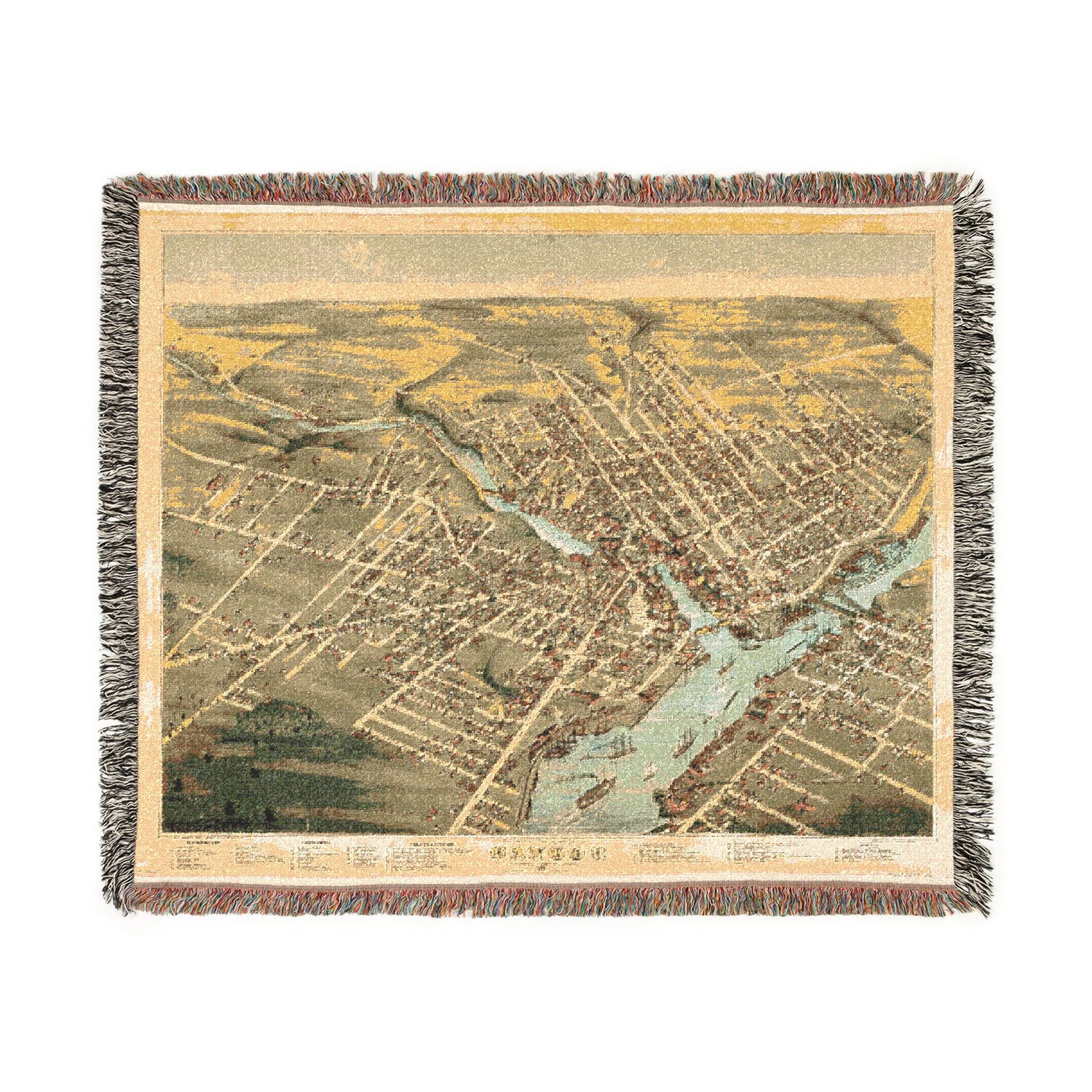 Map-themed woven blanket with tassels on a white background