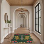 A green rectangular area rug with two golden lions, red flowers, and a central gold trident lies on a light wood floor in a bright hallway with arched walls and large black-framed windows.
