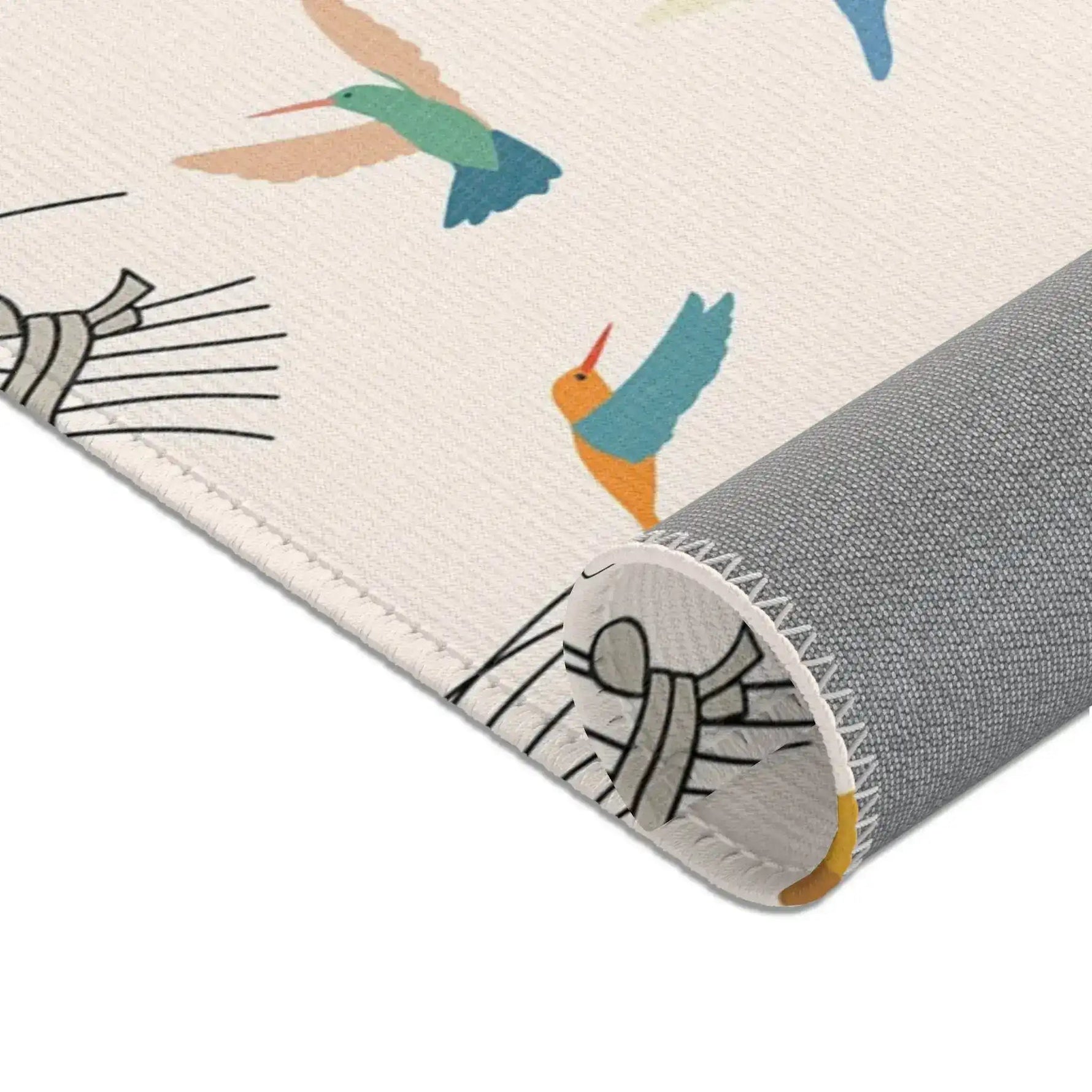 Roll of rug with bird design on a white background
