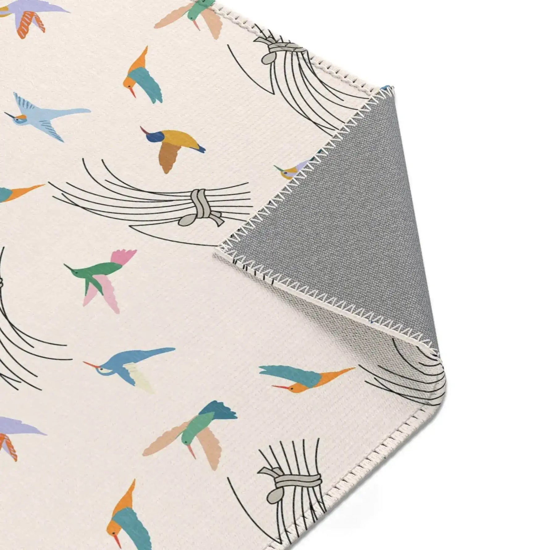 Textile with colorful bird pattern and gray border on a white background