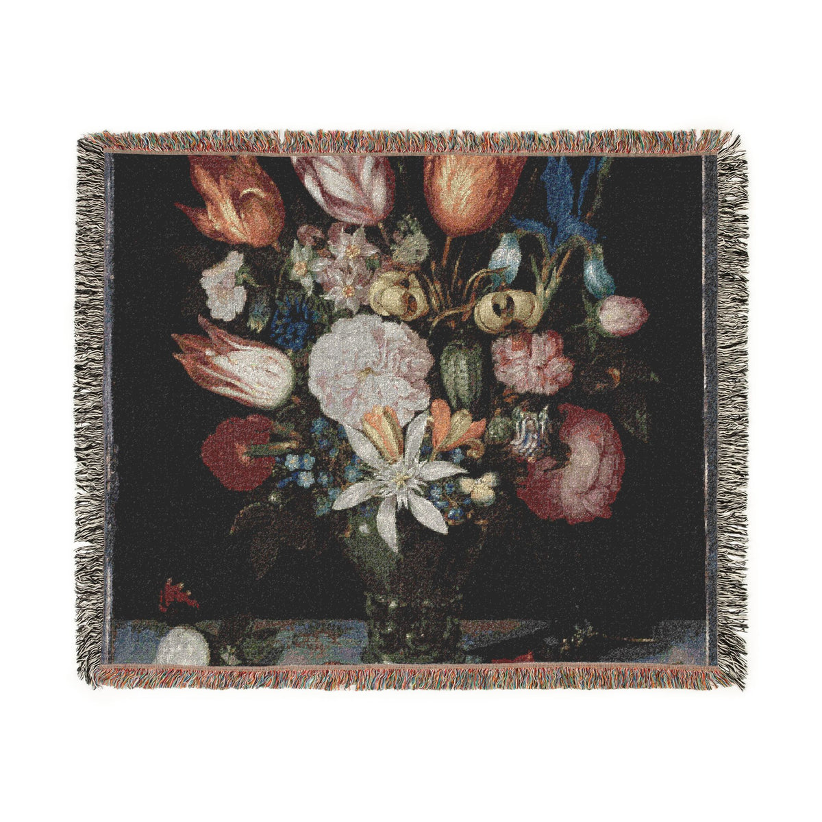 A woven throw blanket featuring a classic still life tapestry design of a flower bouquet in a dark vase, finished with fringed edges.