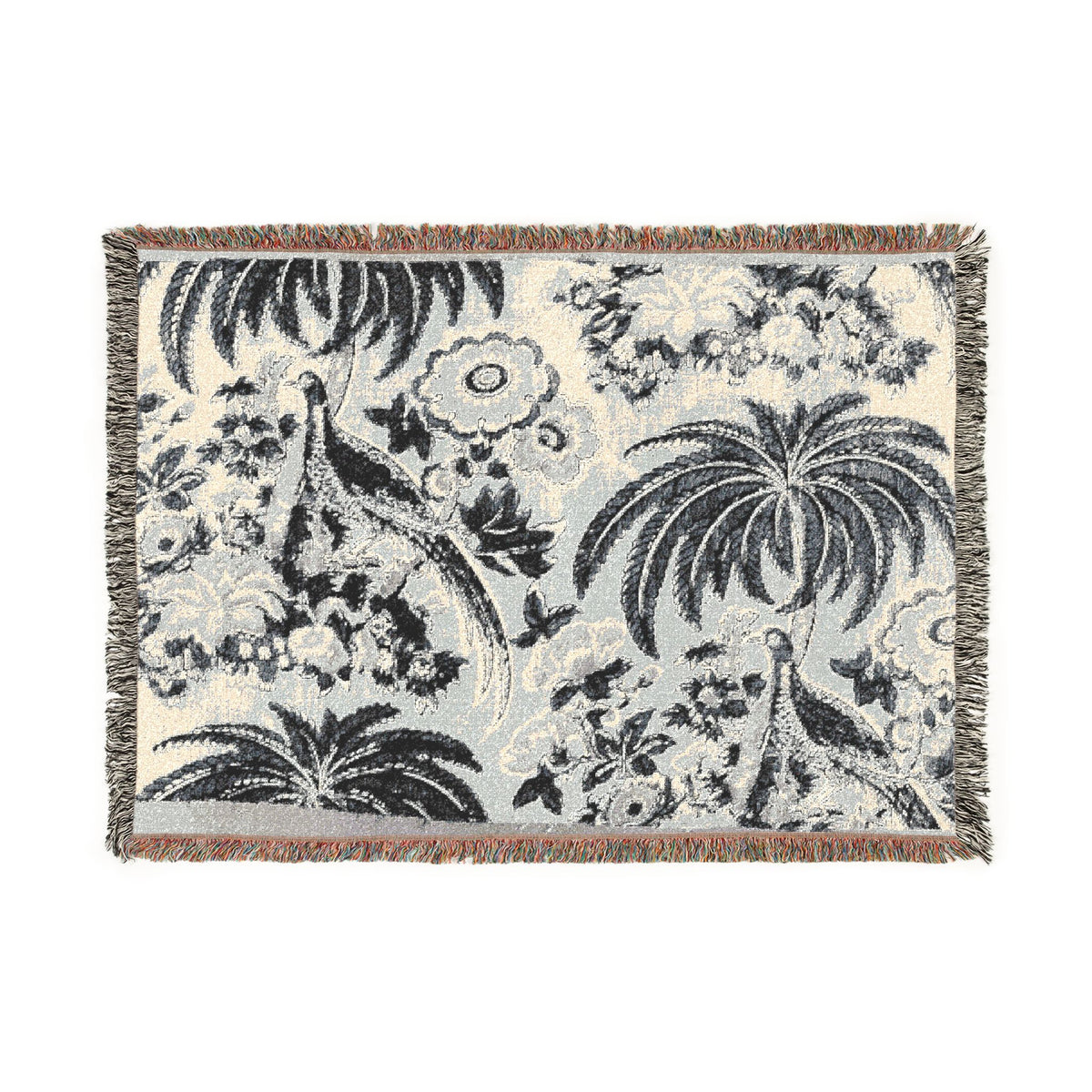 A rectangular woven throw blanket with fringed edges, featuring a botanical and bird pattern in black, gray, and off-white.
