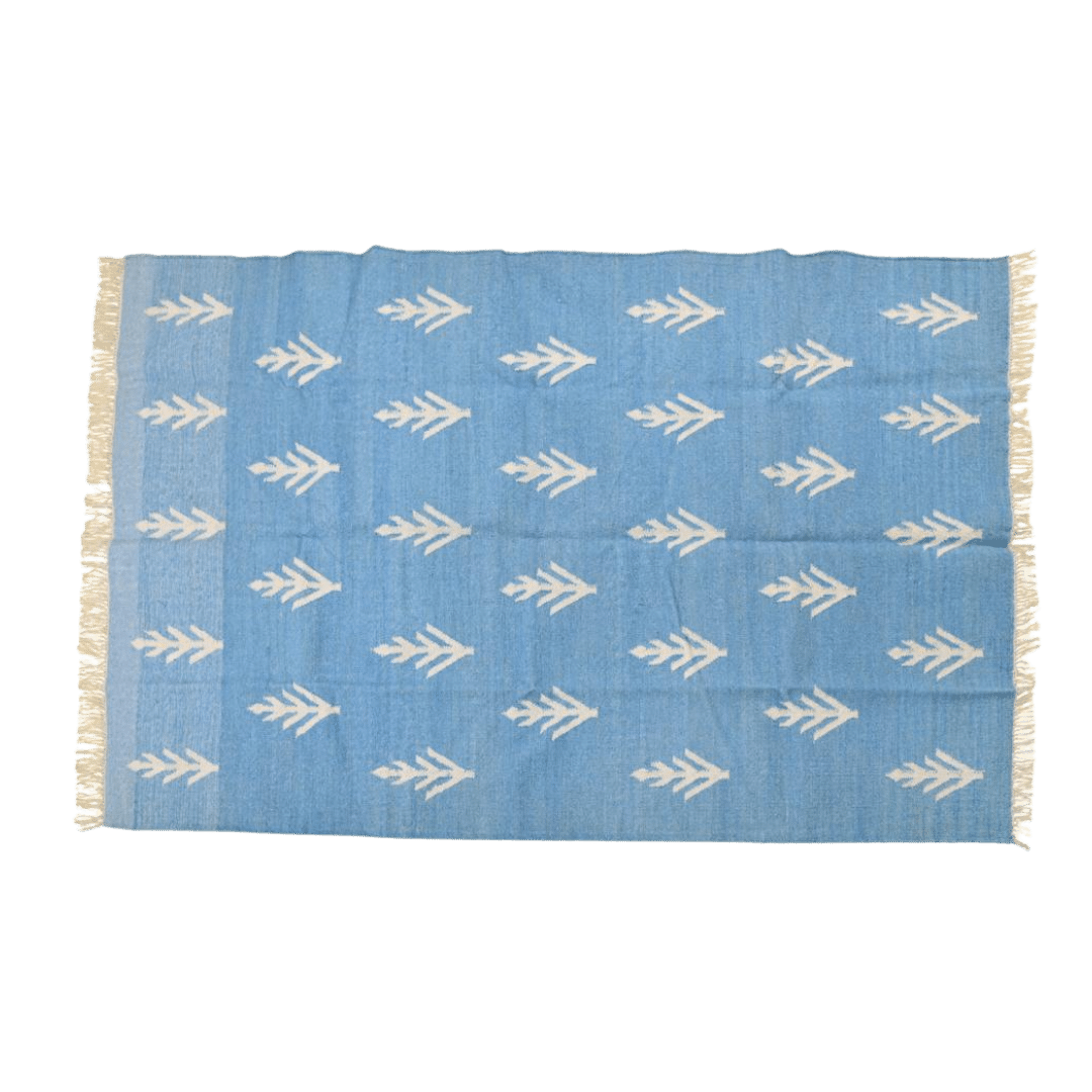 Handwoven White Floral Blue Cotton Rug with Fringes" - Infuse your space with floral elegance using this handwoven cotton rug. Delicate white florals on a serene blue background create a calming atmosphere. Finished with fringes, it adds a touch of charm to any room. Perfect for those seeking to bring a touch of nature indoors with style and grace.