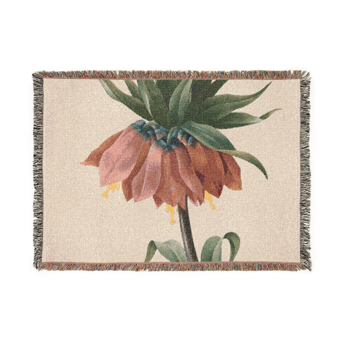 A rectangular woven throw blanket with fringed edges, featuring a botanical print of a brownish-pink flower with green leaves on a warm beige background.